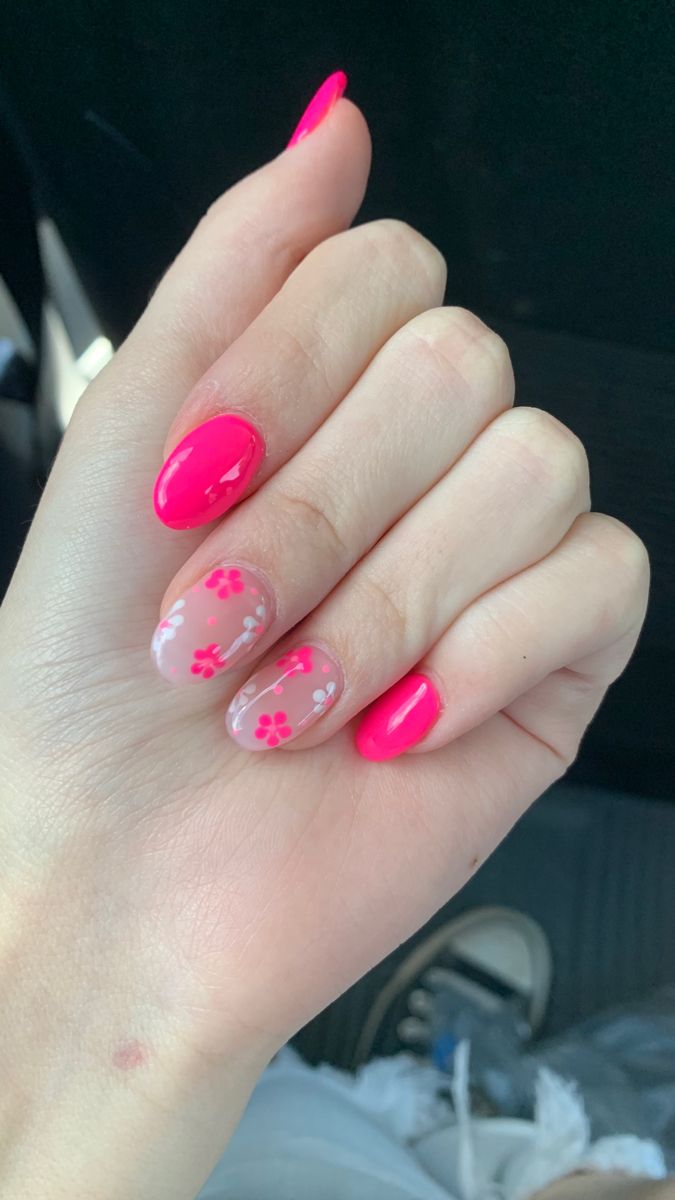 Striking Hot Pink Nail Design with Charming Floral Accents for a Playful Elegance.