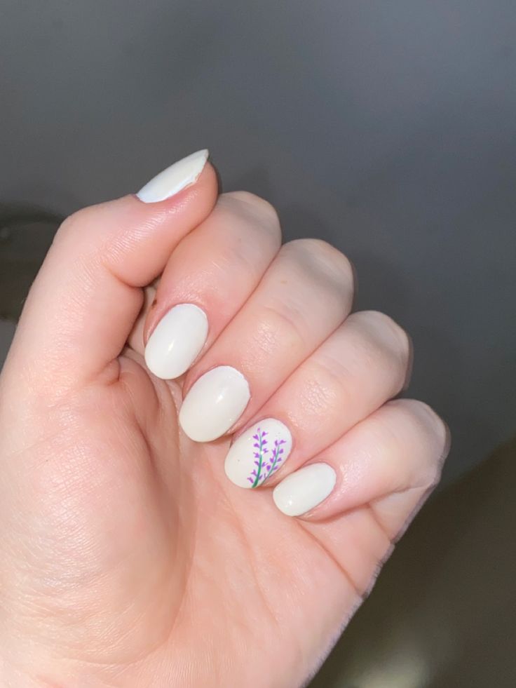 Elegant Nail Design with Creamy Base and Intricate Floral Accents