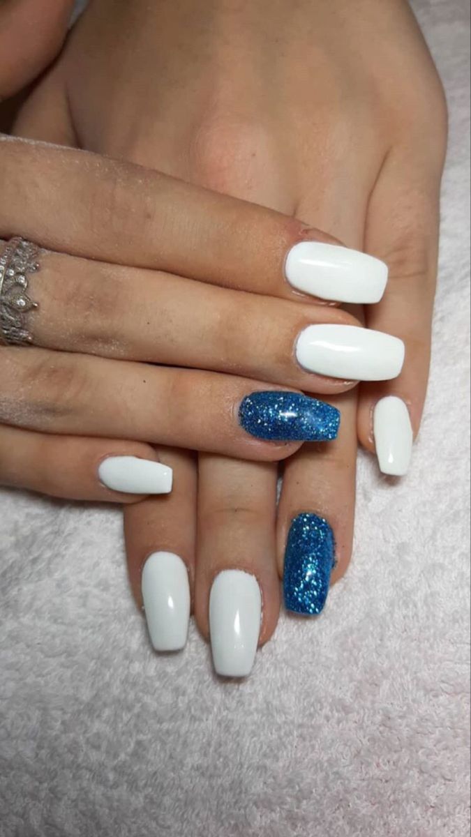 Chic Elegant Nail Design: Classic White with Vibrant Blue Glitter Accent