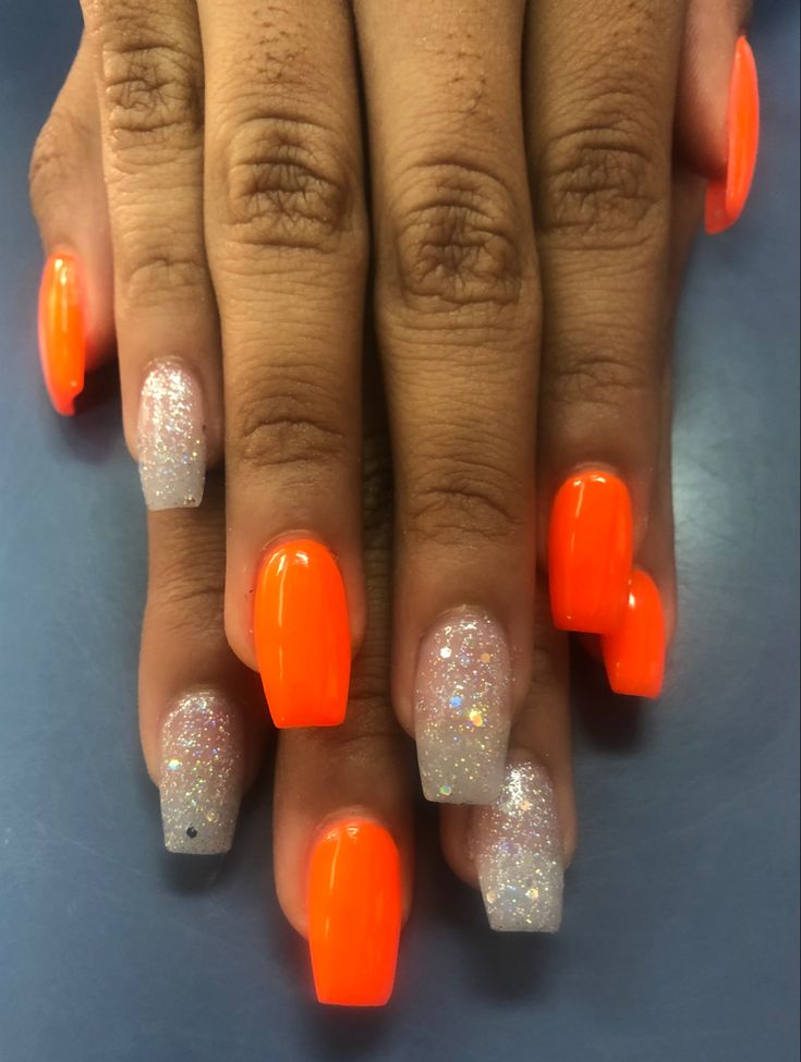 Vibrant Bold Orange Nail Design with Sparkling Silver Glitter for a Glamorous Aesthetic