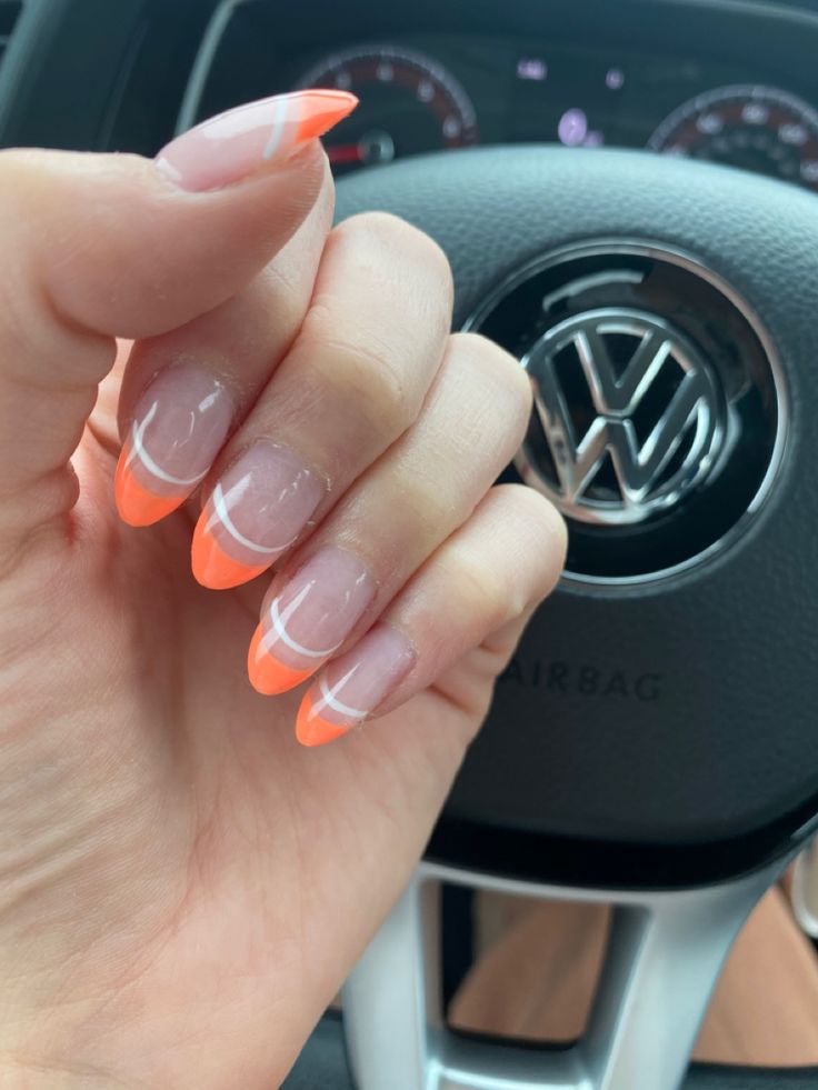 Vibrant Twist on Classic French Manicure: Bold Orange Tips with Elegant White Details.