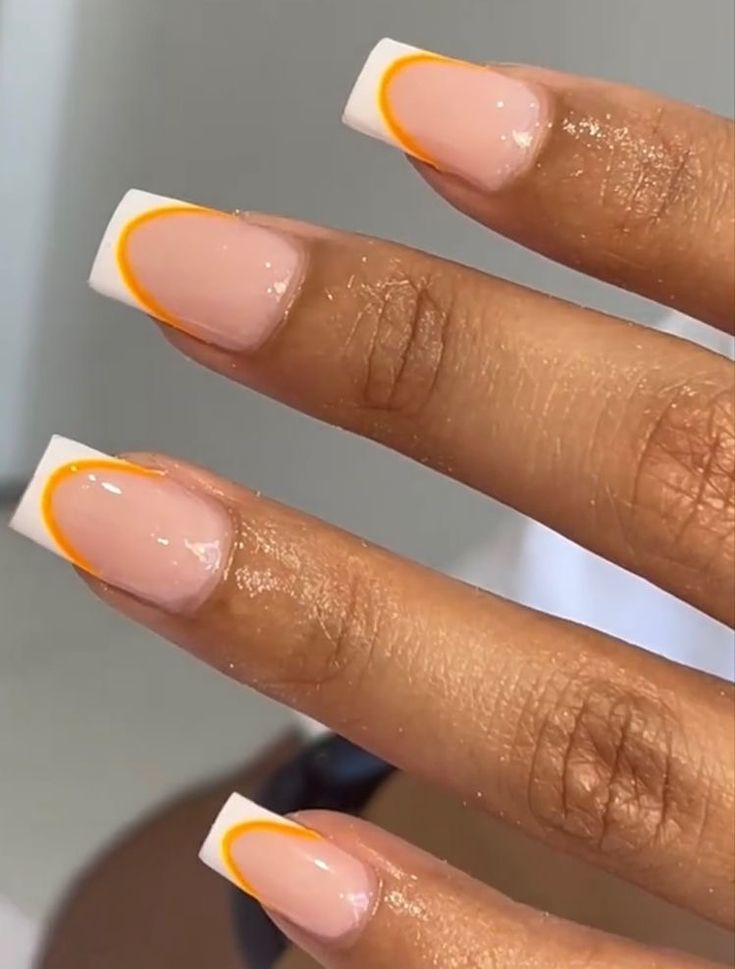 Chic French Tip Nails: A Modern Fusion of Soft Pink, Crisp White, and Vibrant Orange Accents.