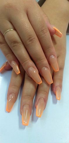 Chic Almond Nails: Vibrant Orange Tips on a Nude Base for a Modern Twist.