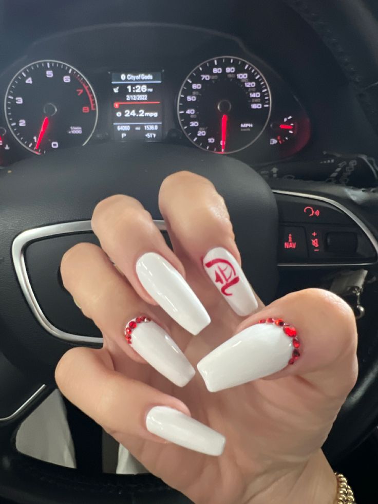 Chic Long White Square Nail Design with Glamorous Red Gemstone Accents and Vibrant Graphics.