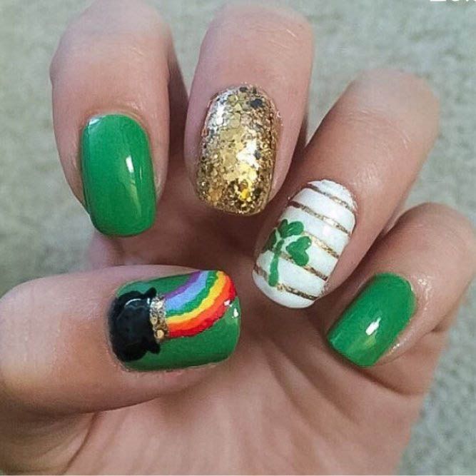 Festive Green Nail Design with Leprechaun Hat, Rainbow, Gold Glitter, and Shamrock Accents.