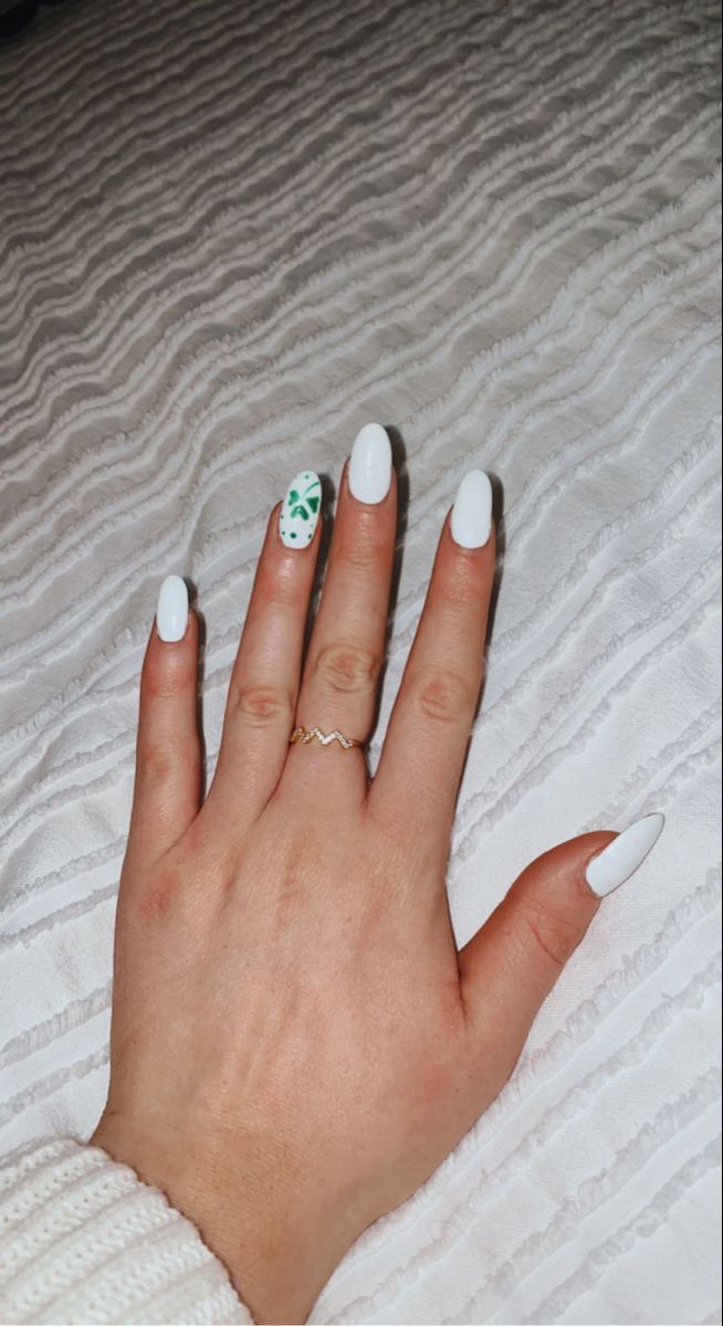 Sophisticated White Base Nail Design with Delicate Green Floral Accent.