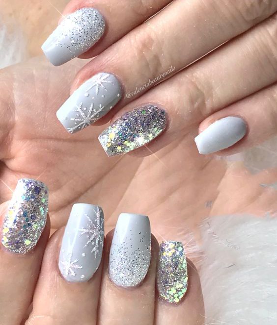 Frosty Winter Nail Design with Glittery Accents and Snowflake Patterns