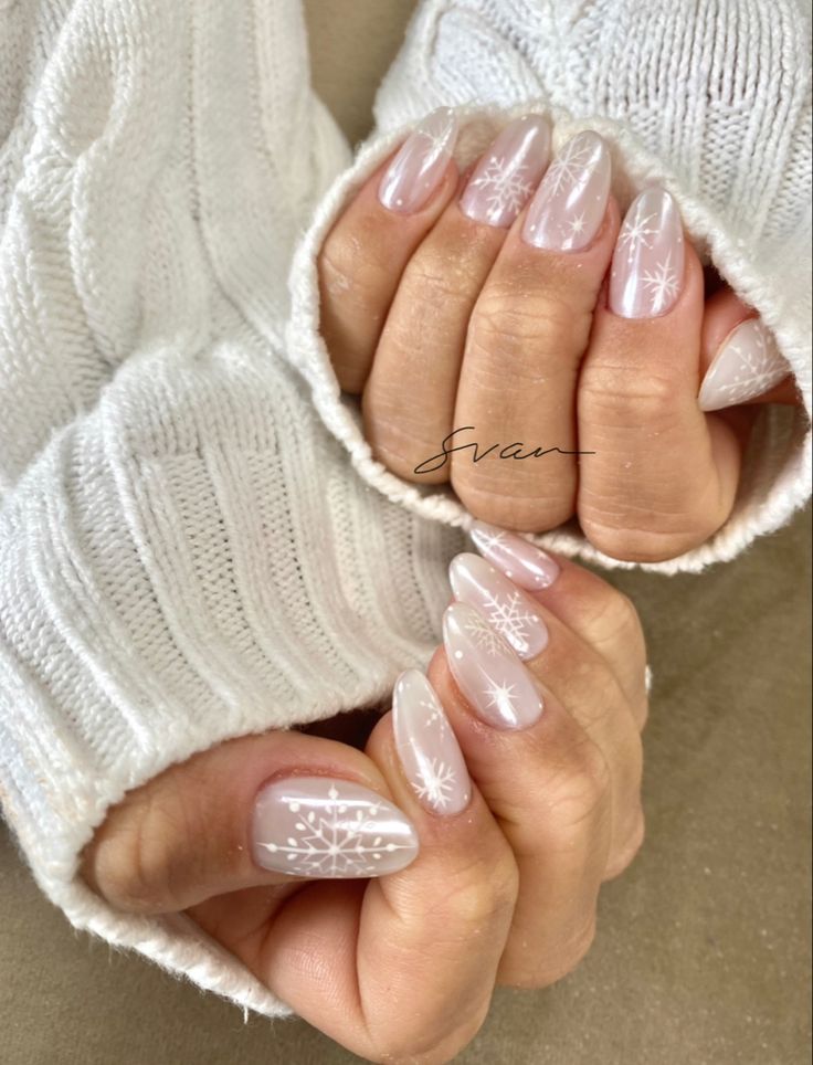 Elegant Winter Nail Design with Sheer Base and Intricate Snowflake Patterns