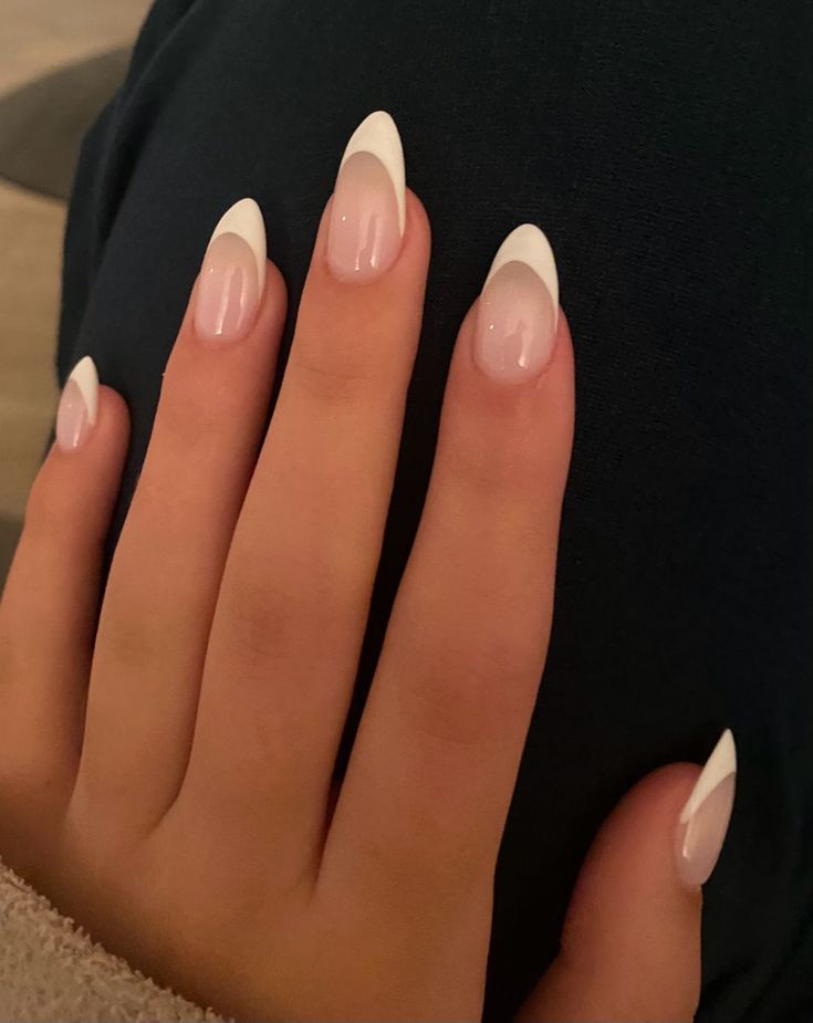 Chic Almond-Shaped Nails: Modern French Manicure with Soft Pink Base and Bold White Tips.