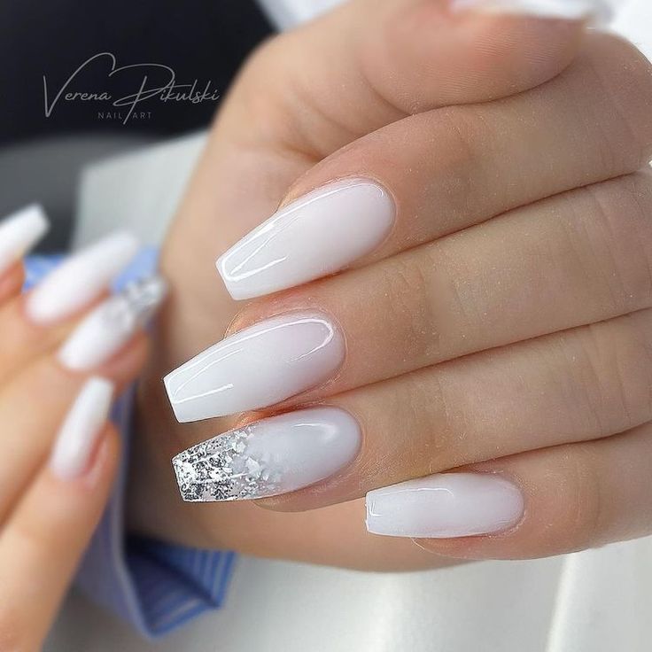 Chic White Ombre Nail Design with Sparkle and Silver Accent.