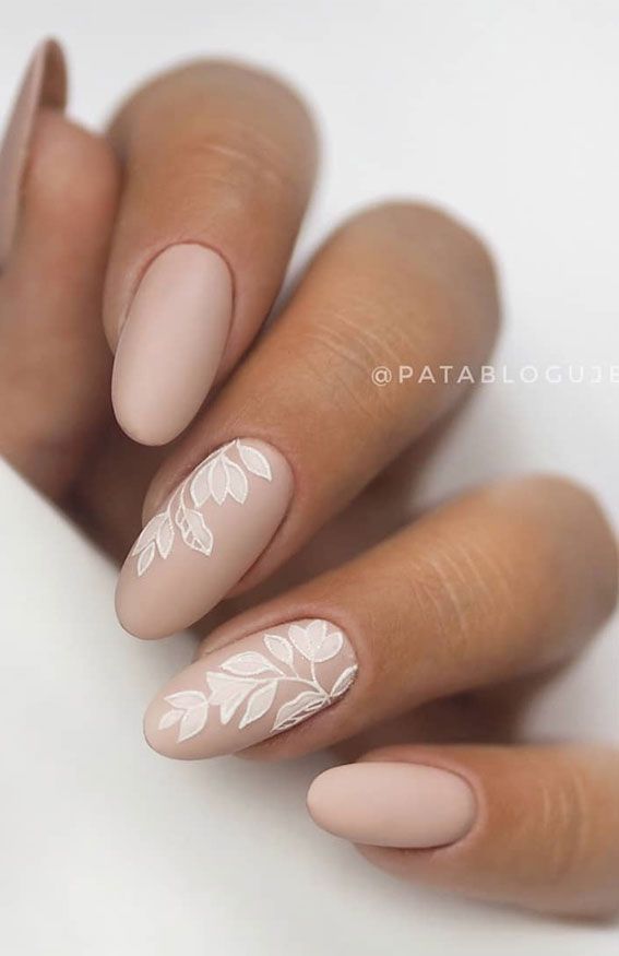 Sophisticated Matte Nude Nails Enhanced with Delicate White Leaf Designs.