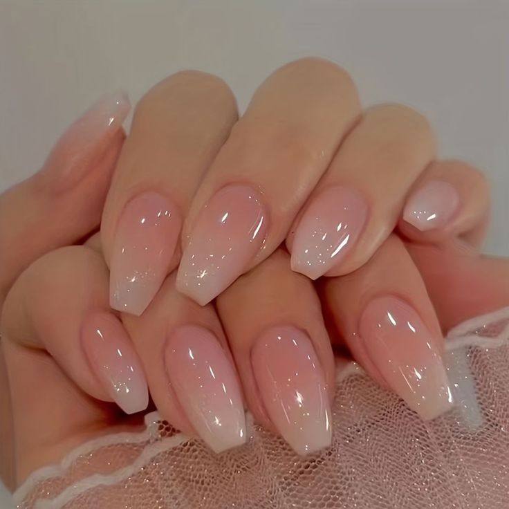 Chic Ombre Nail Design: Soft Pink to Sheer Glossy Finish with Almond Shape