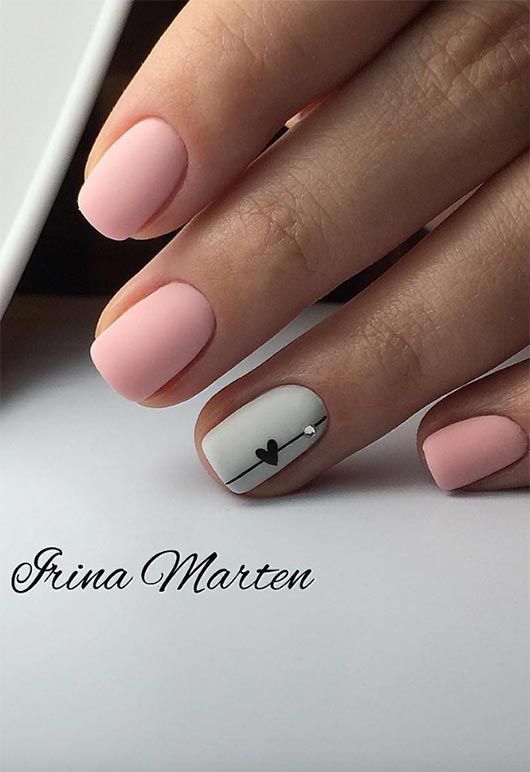 Chic Matte Pink Nail Design with Heart Accent for a Contemporary Look.