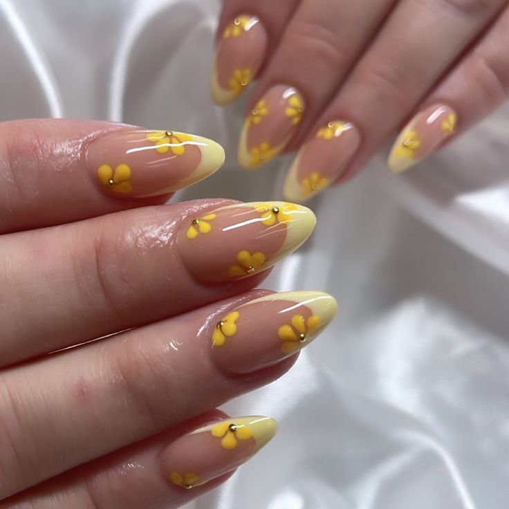 Vibrant Floral Nail Design: Soft Nude Base with Cheerful Yellow Tips for Spring/Summer.