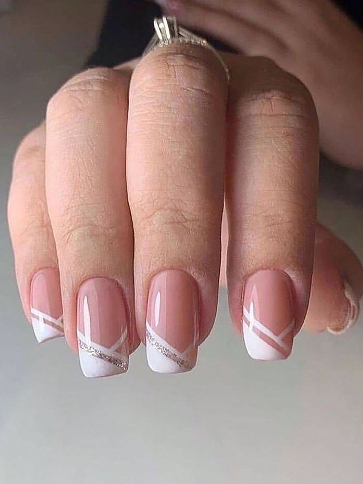 Sophisticated Nude and White Nail Design with Sparkling Diagonal Accents