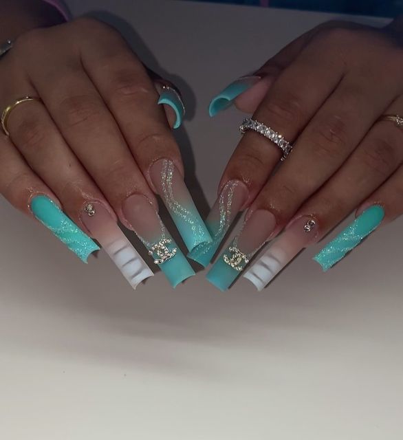 Glamorous Almond-Shaped Nail Design: Turquoise and Pastel Shades with Intricate Patterns and Jewel Accents