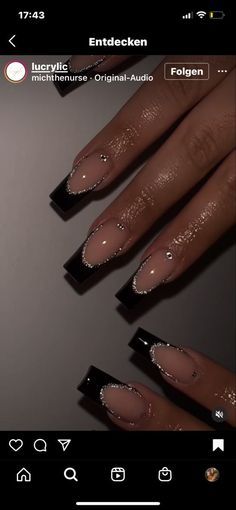 Chic Nude and Black Nail Design with Glamorous Accents