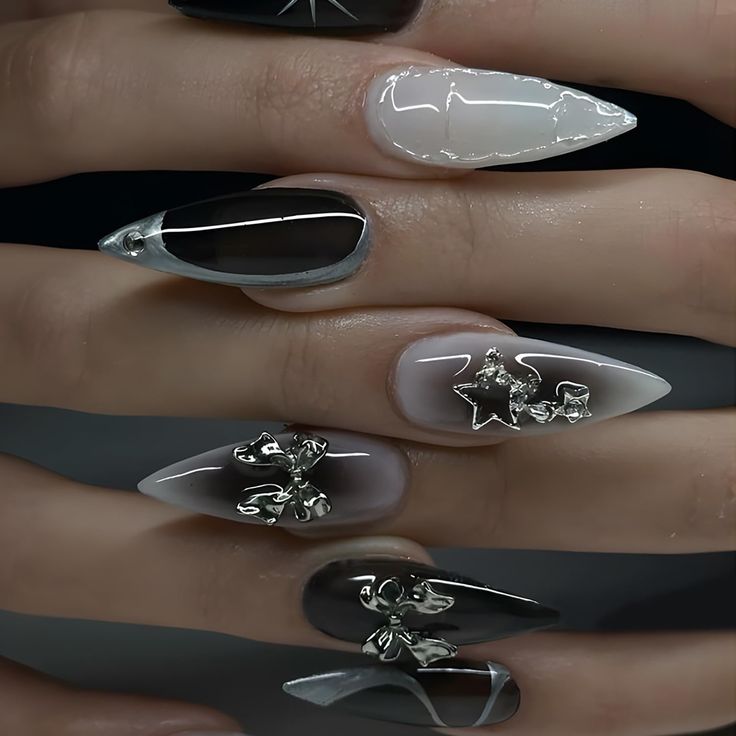 Chic Black and White Nail Design: Edgy Shapes, Glamorous Silver Accents, and Dynamic Finishes.