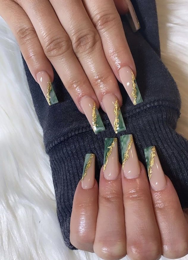 Elegant Nude and Deep Green Geometric Nail Design with Glossy Finish and Gold Accents.