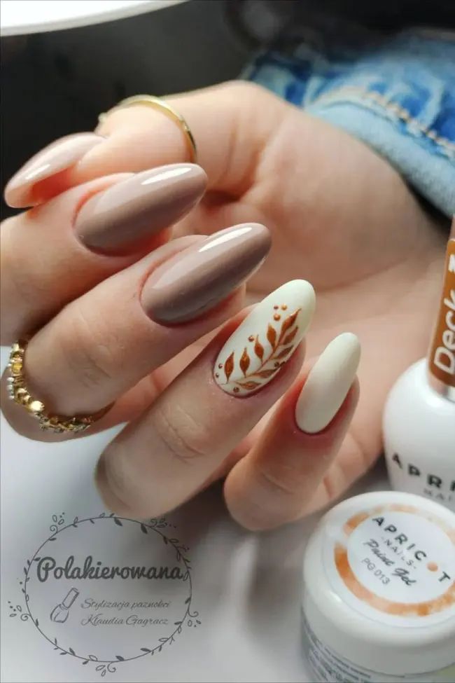 Sophisticated Almond-Shaped Nails with Soft Neutrals and Earthy Floral Accents.