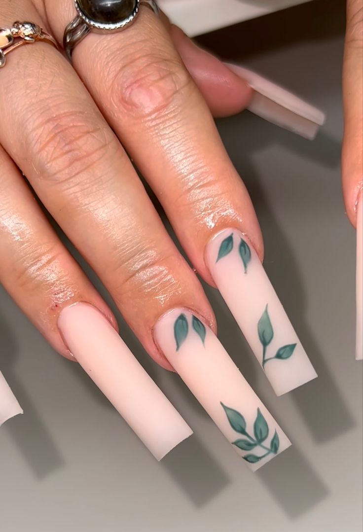 Sophisticated Matte Nude Nail Design with Delicate Green Leaf Accents