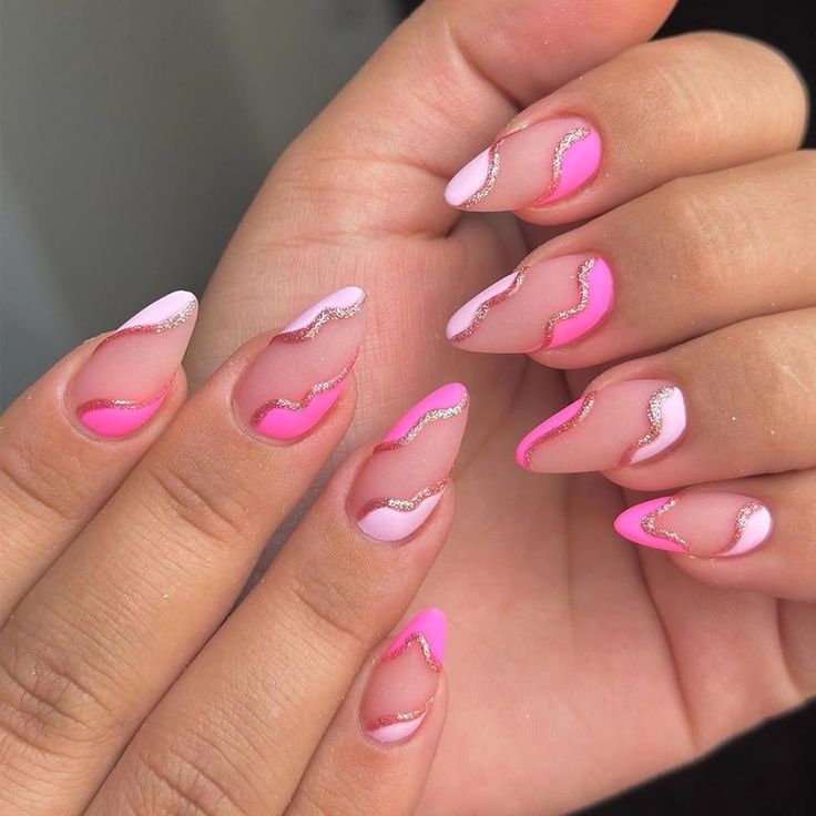 Vibrant Gradient Pink Nail Design with Elegant Wavy Patterns and Glitter Accents.