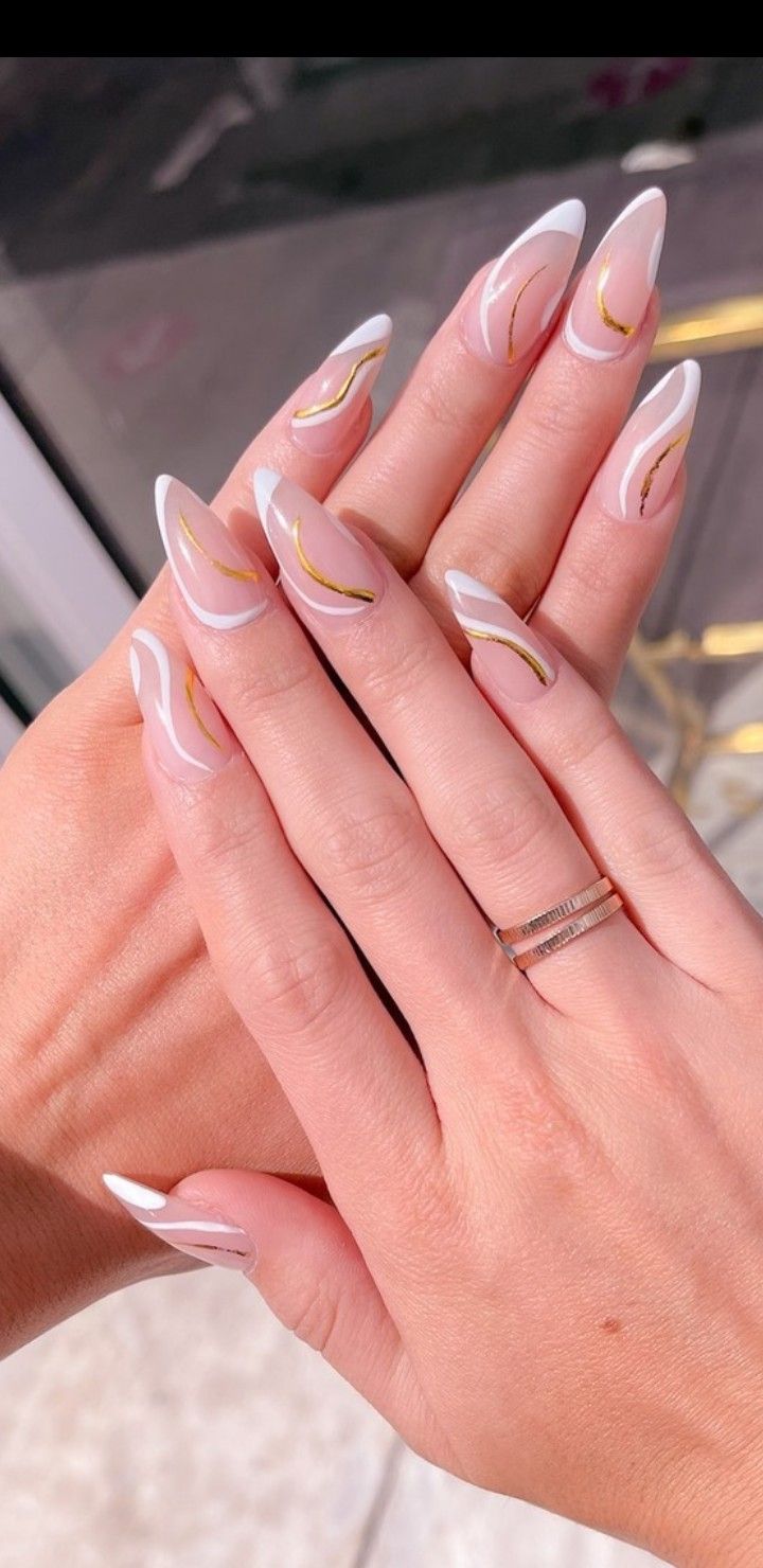 Chic White and Gold Nail Design with Elegant Long Tapered Shape.