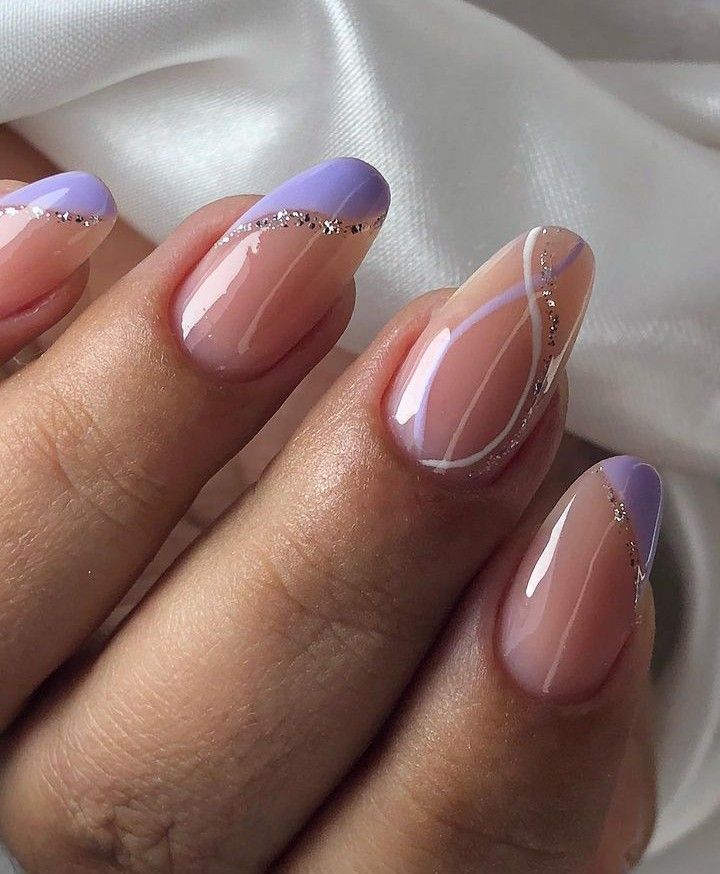 Chic Angular Nail Design with Muted Nude and Soft Lavender, Enhanced by Metallic Accents and Glossy Finish.