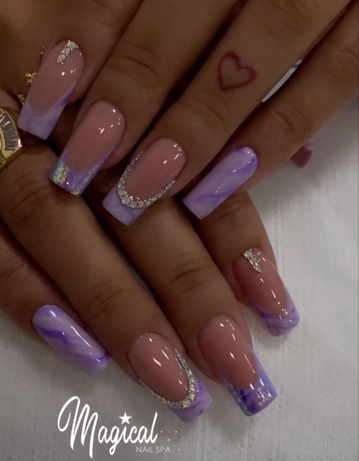 Sophisticated Lavender and Nude Nail Design with Intricate Patterns and Sparkling Accents.