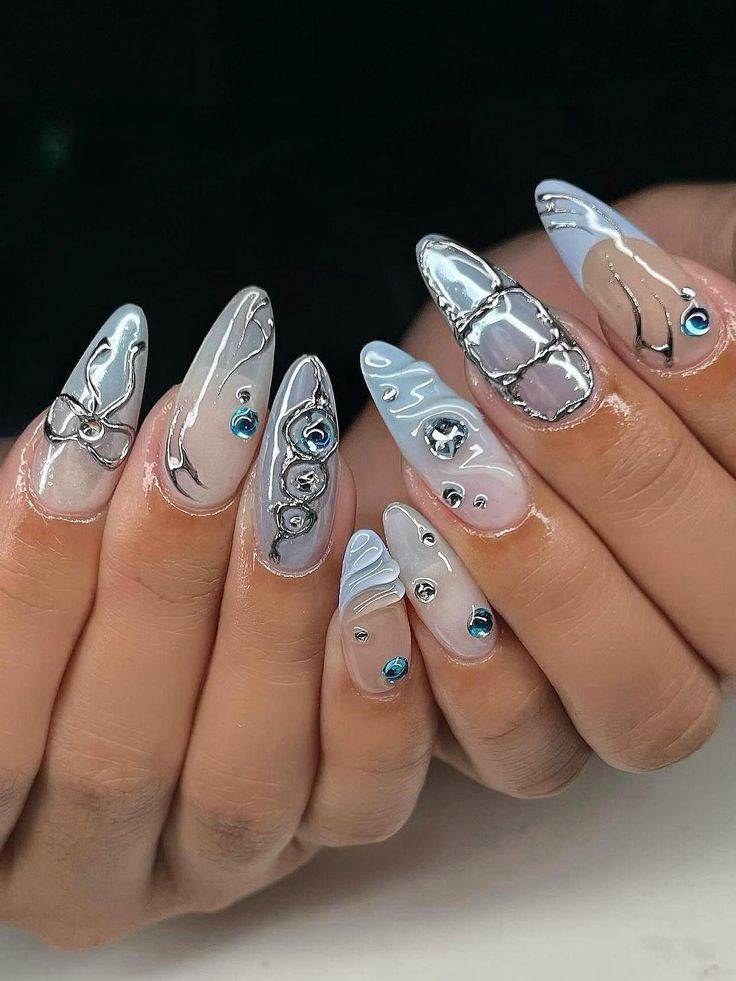 Elegant Intricate Nail Design with Glossy Light Colors, Metallic Accents, and Rhinestones.