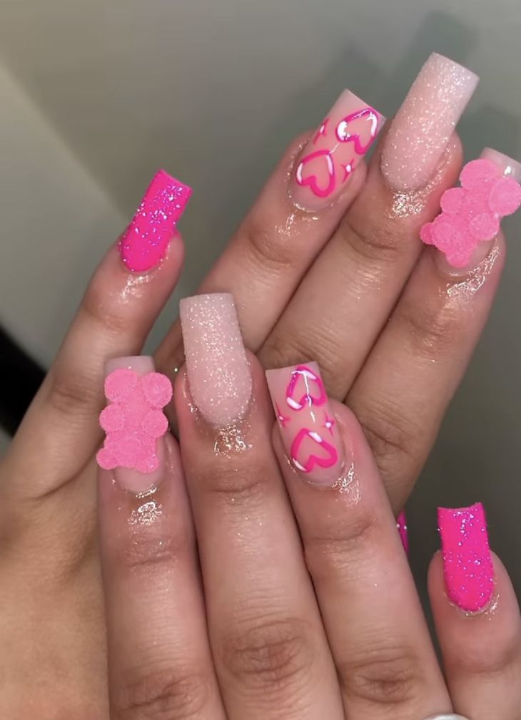 Playful Vibrant Pink Nail Design with Textures and Whimsical Motifs