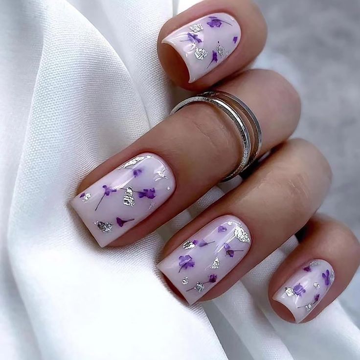 Charming Floral Nail Design with Lavender Base and Metallic Accents