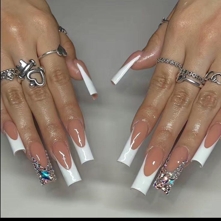 Glamorous Long Tapered Nails with Nude and White Polish Accented by Rhinestones.