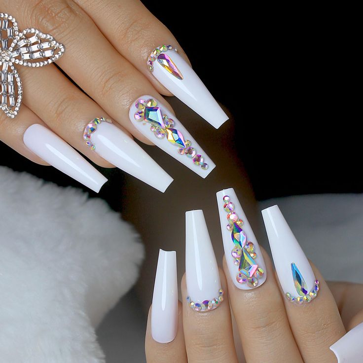 Captivating Elegant White Nails with Iridescent Rhinestones and Geometric Patterns.