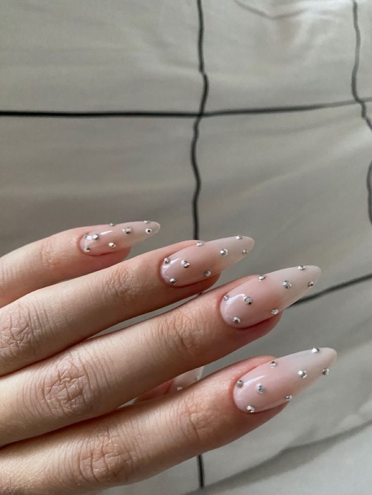 Chic Almond Nail Design with Subtle Nude Base and Silver Studs