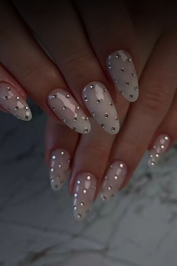 Sophisticated Almond-Shaped Nail Design: Soft Nude Base with Delicate Silver Studs