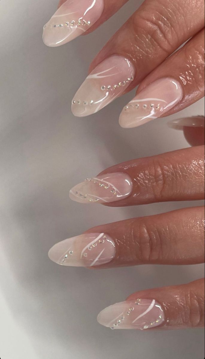 Sophisticated Almond-Shaped Nude Nail Design with Delicate White Geometry and Pearls.