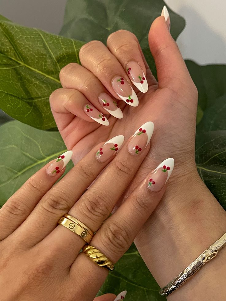 Chic Almond-Shaped Nail Design with Classic French Tips and Playful Cherry Accents