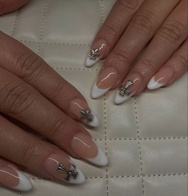 Chic French Tip Nail Design with Intricate Metallic Embellishments