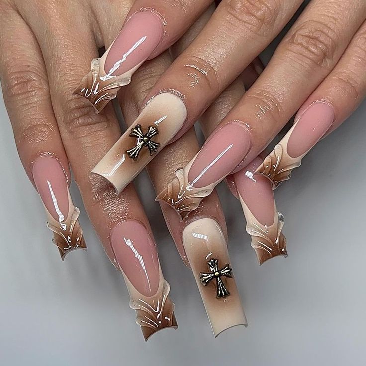 Stylish Long Square Nail Design with Soft Pink and Nude Gradient, Enhanced by Metallic Cross Embellishments.