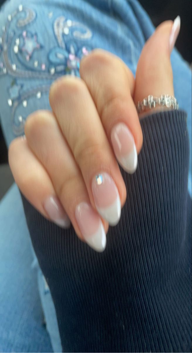 Elegant French Manicure with Soft Pink, Classic White Tips, and Sparkling Accent Stones.