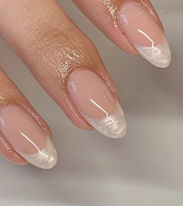 Modern French Manicure: Elegant Soft Nude with Delicate White Tips and Glossy Finish.