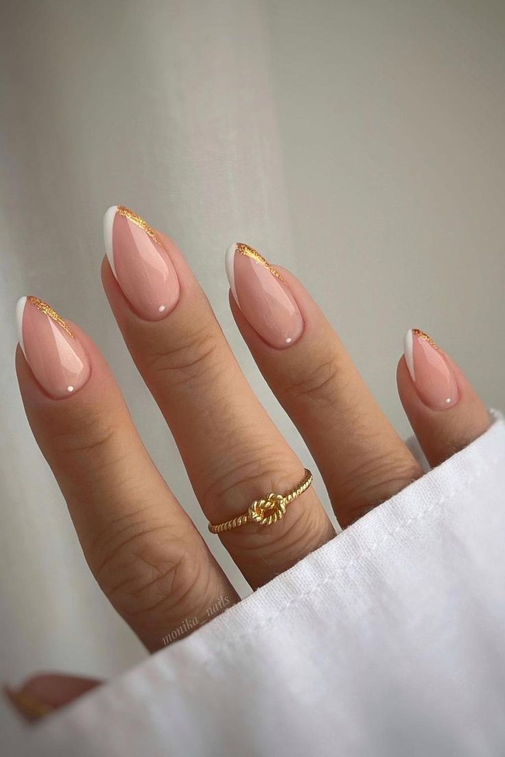 Chic Nude Almond Nails with Glossy Finish and Gold Accents for Elegant Style.