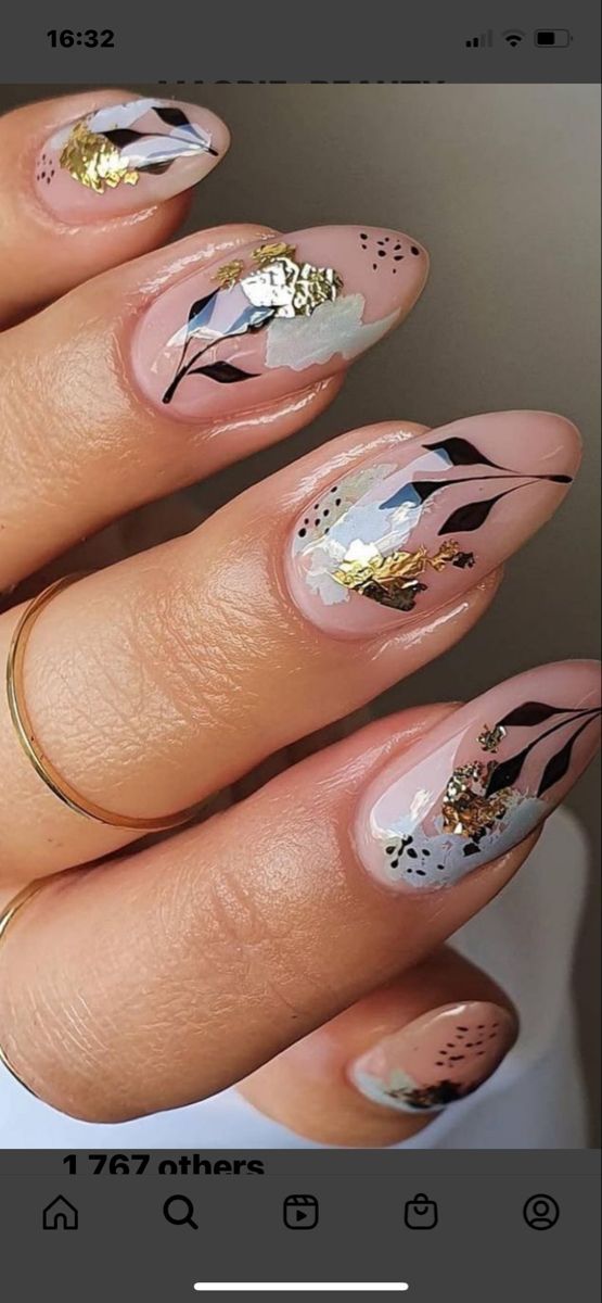 Elegant Floral Nail Design with Gold Accents and Sophisticated Finish.