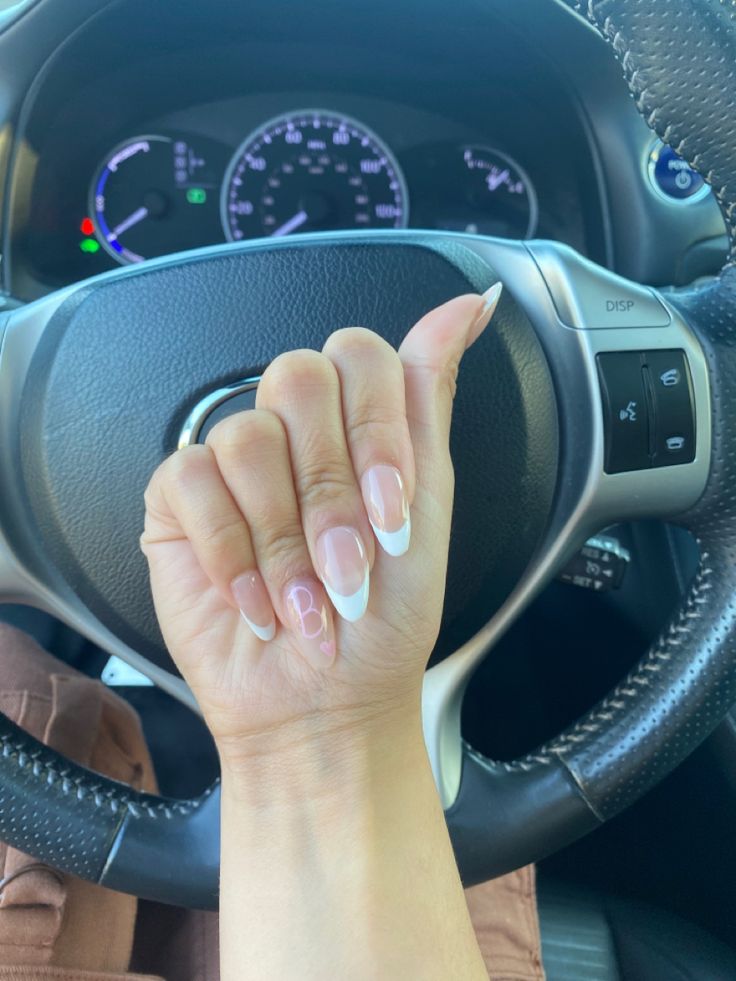 Sophisticated French Tip Manicure with Modern Ombre Effect Highlighted by Stylish Car Interior