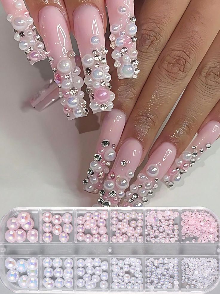 Elegant Long Pink Nail Design with Pearls, Rhinestones, and Decorative Beads for a Luxurious Look.