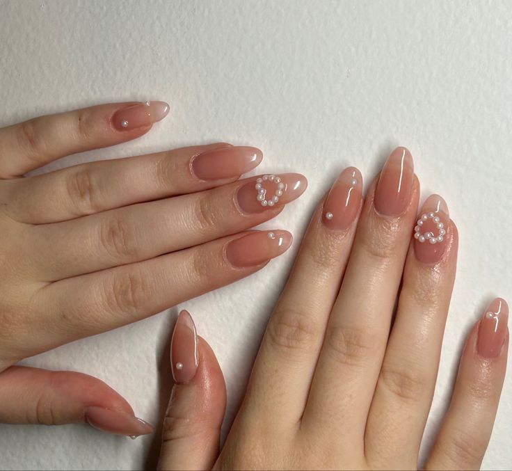 Sophisticated Soft Nude French Tip Nail Design with Pearl-Like Accents