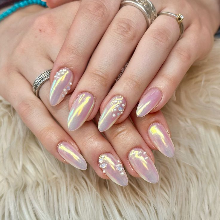 Elegant Iridescent Nail Design with Elongated Tips and Pearl Embellishments in Soft Pink Hues.