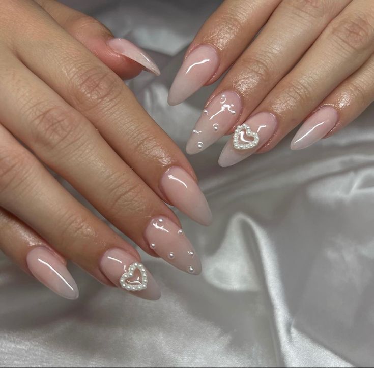 Chic Almond-Shaped Nails with Soft Pink Gradient and Romantic Embellishments.