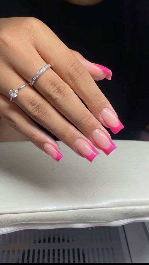 Chic Manicure: Modern French Tips with Vibrant Pink Accents.